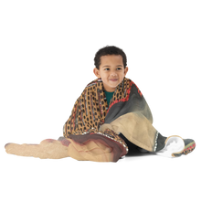 Load image into Gallery viewer, Child wrapped in Divine Reflection throw blanket featuring artwork by Philadelphia artist Andromeda Cook